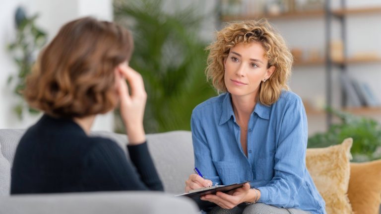 A woman therapist listens to her patient